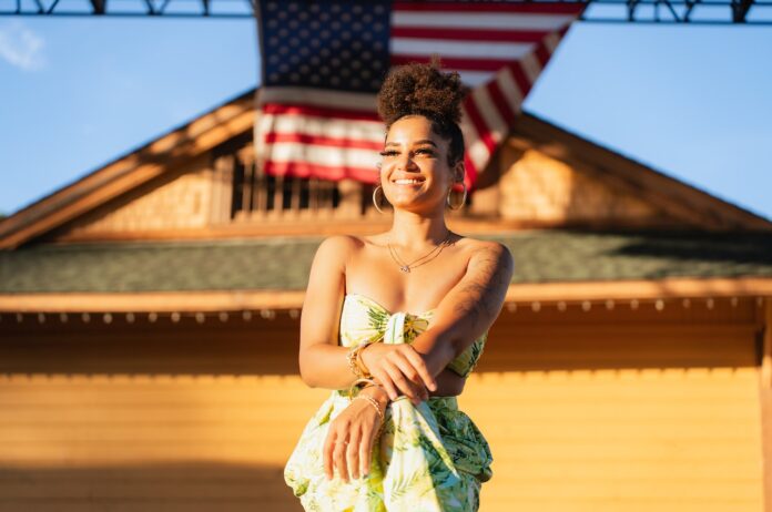pexels-ty-rodriguez-17884120 Photo by Ty Rodriguez : https://www.pexels.com/photo/woman-posing-in-front-of-a-building-with-flag-17884120/