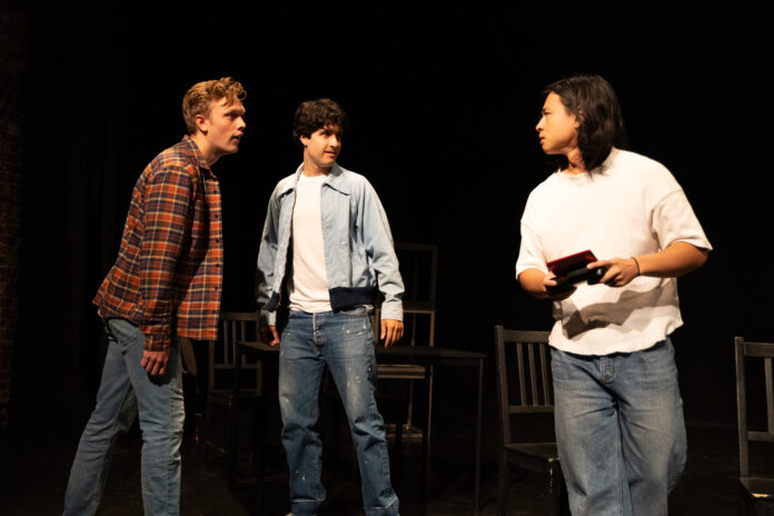 Bullying scene during My Tiger at the Brickhouse Theatre, with two other performers seated in the background.