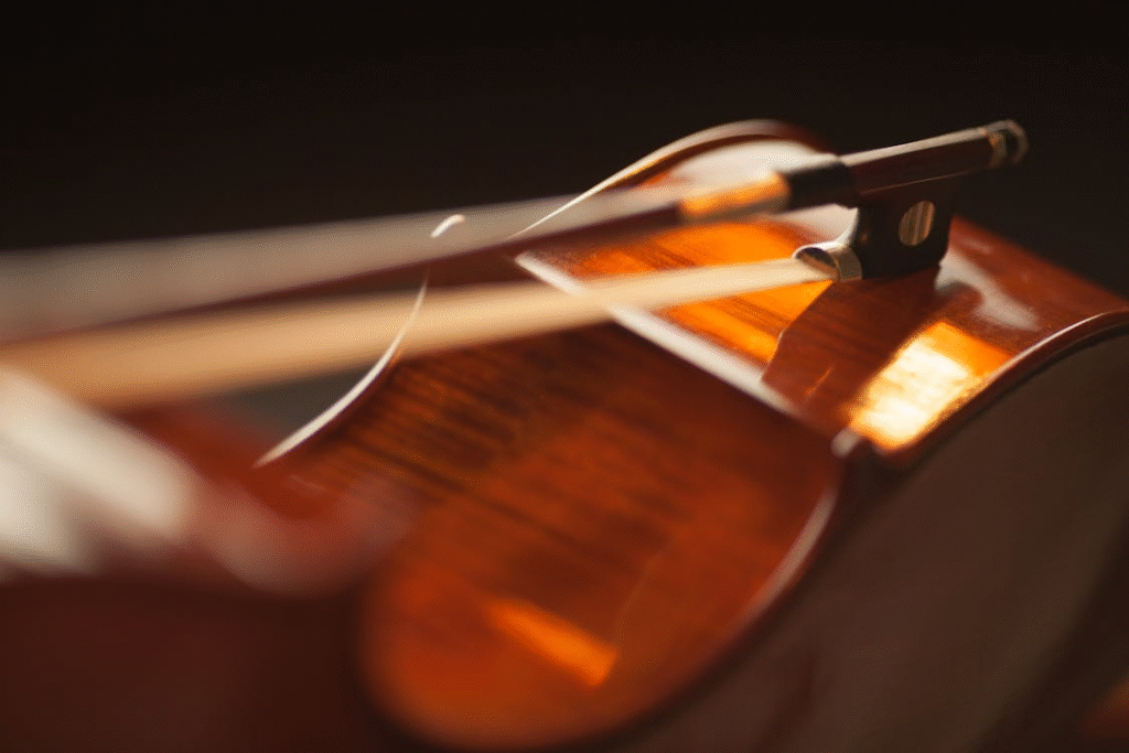 A violin and bow placed gently on a table, highlighting the importance of proper storage and instrument care. Photo by Méline Waxx.