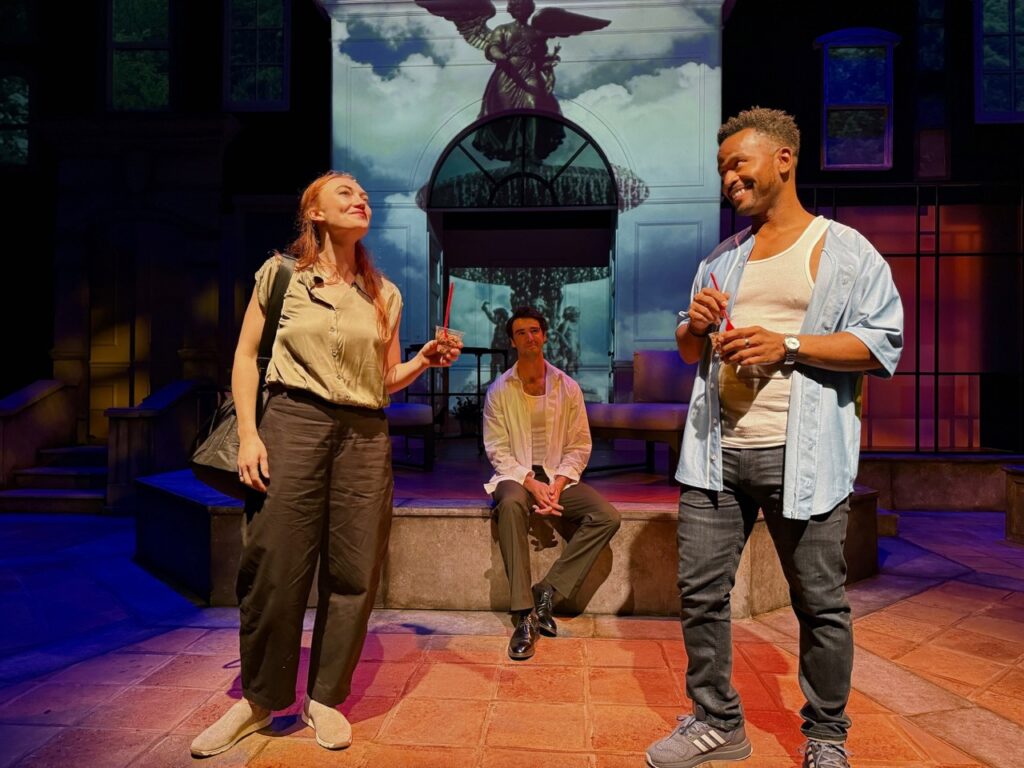 Scene from I’ll Give You My Heart featuring three cast members in an outdoor setting at the Colony Theatre.