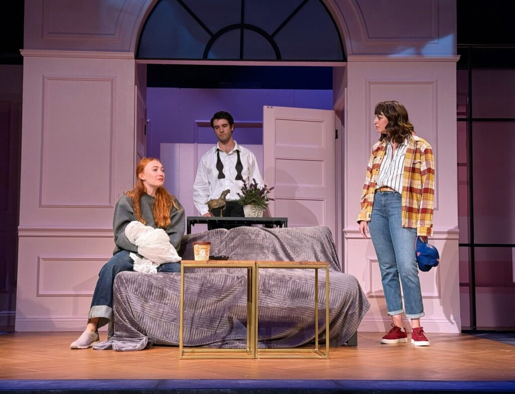 Three actors in a living room scene from I’ll Give You My Heart at the Colony Theatre.