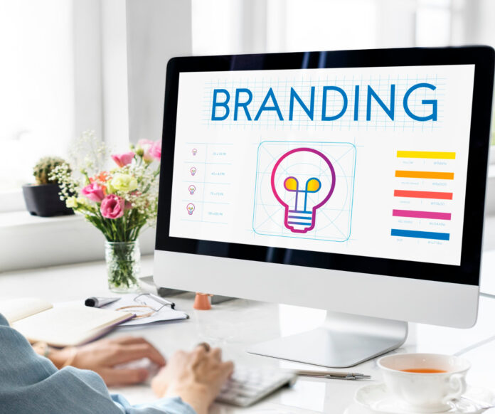 Brand Identity Design Concept on Computer Designer working on a branding concept at computer with color palette, logo design, and brand layout on screen