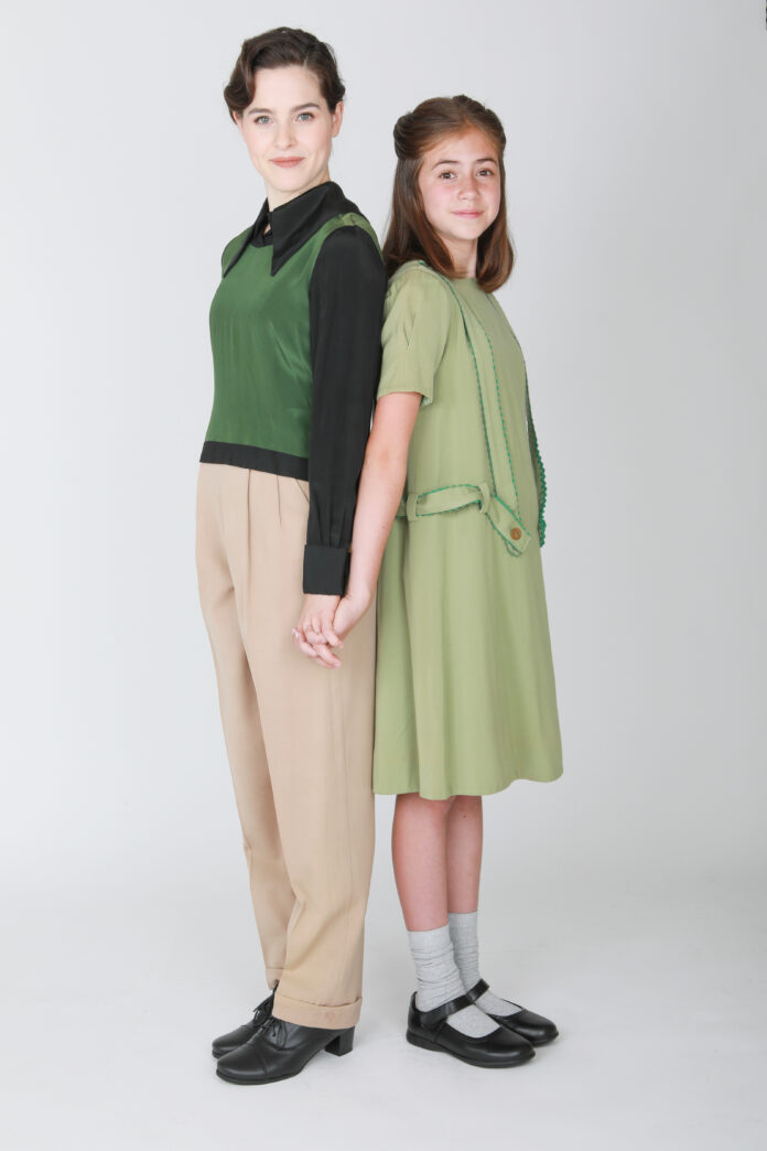 Actors Gabbie Adner and Charley Rowan McCain portray Barbara and Young Barbara in Perfect World: A New Musical, standing hand in hand.