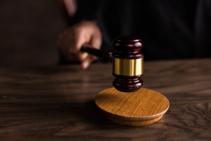 Brown wooden gavel resting on a judge’s table, symbolizing justice, discipline, and what it takes to win a personal injury lawsuit.