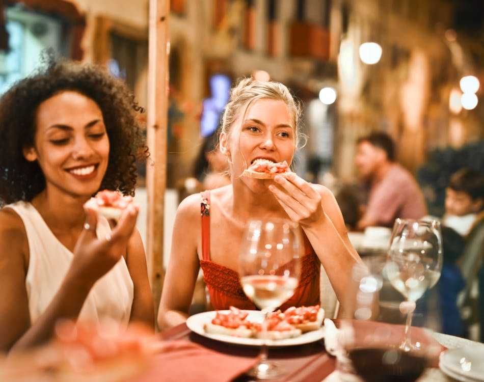 Woman enjoying bruschetta at an outdoor cafe
