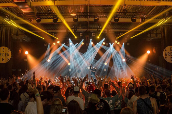 NoHo entertainment in 2025 Concert crowd watching a live band on stage with bright lights.