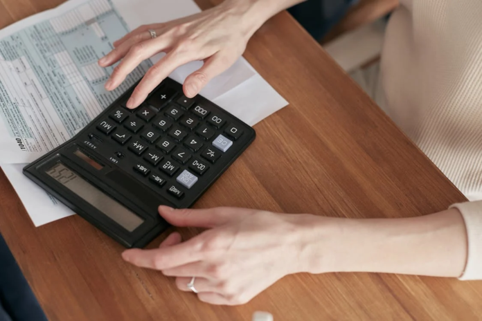 Best Tips for Budgeting in an Arts District Community Woman handing money to another person during a financial discussion
