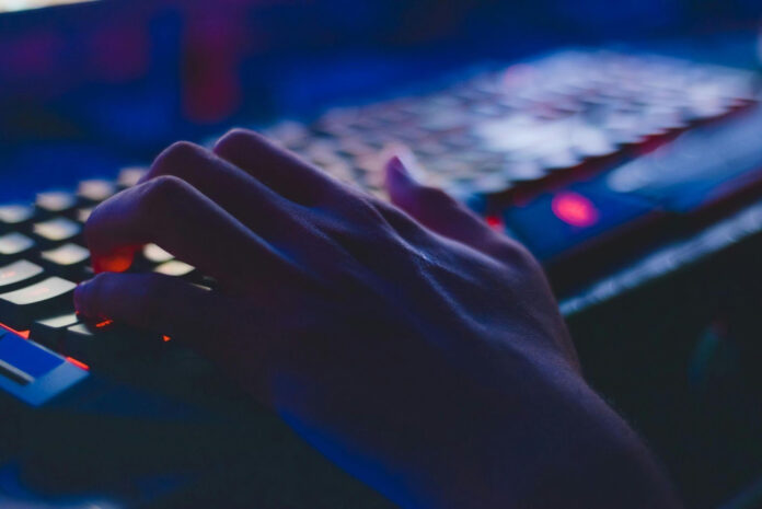 cyber threats esports industry person typing on keyboard