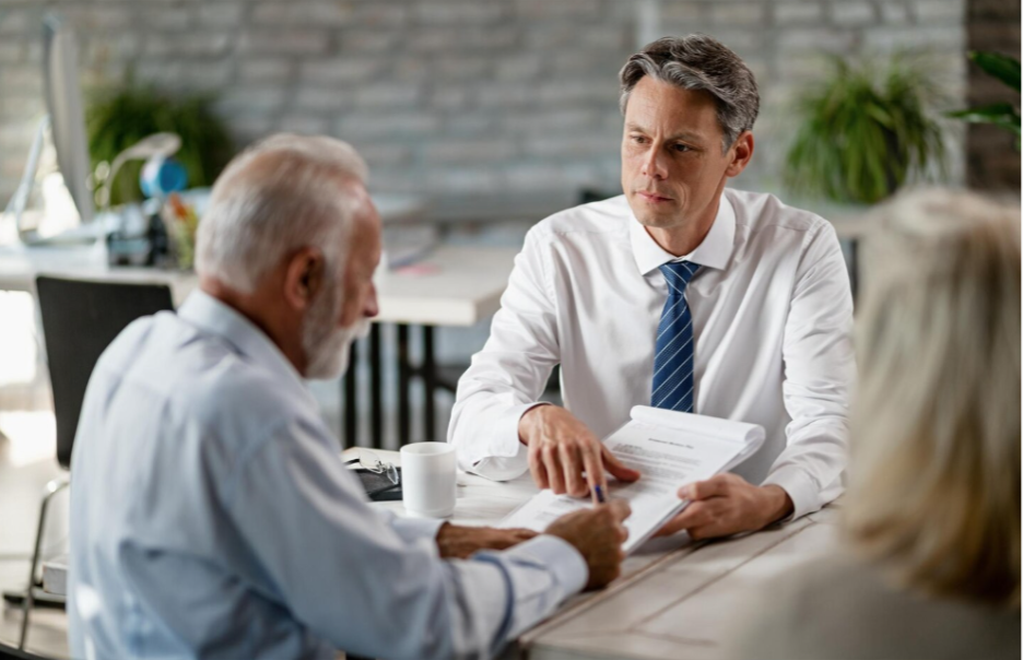 Estate planning lawyer reviewing documents with senior clients