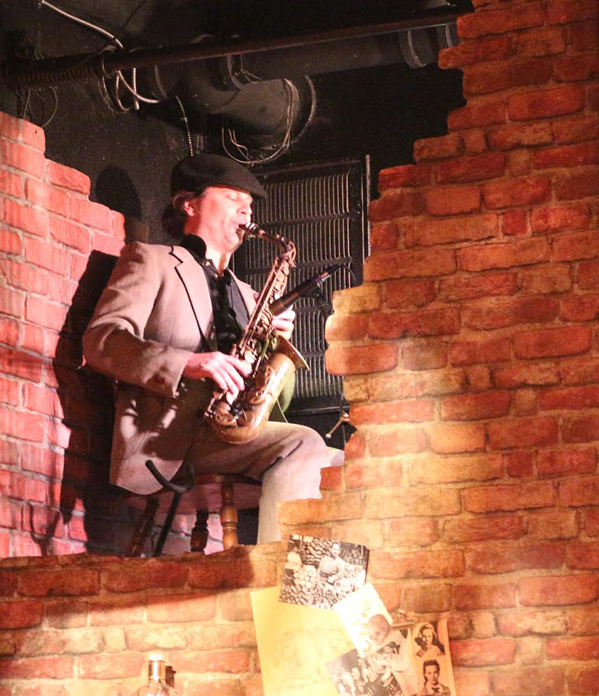 Saxophone player performing live during The Typist stage production