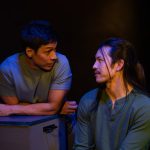 Luca and Uri in close conversation during stage performance