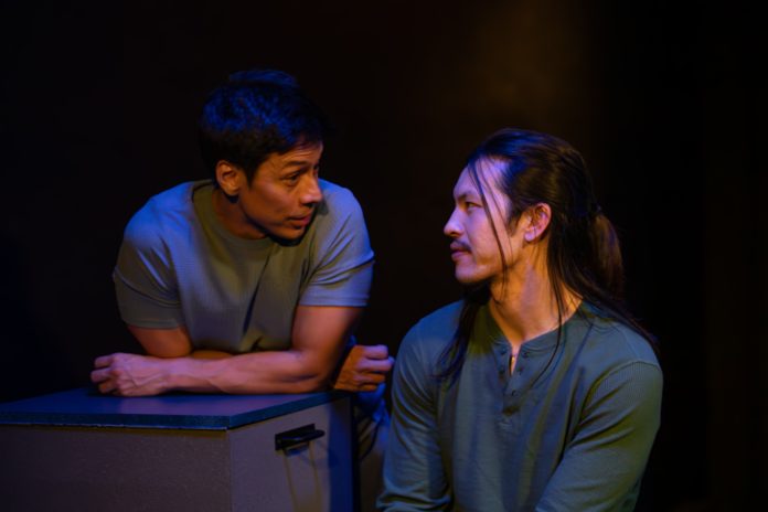 Luca and Uri in close conversation during stage performance