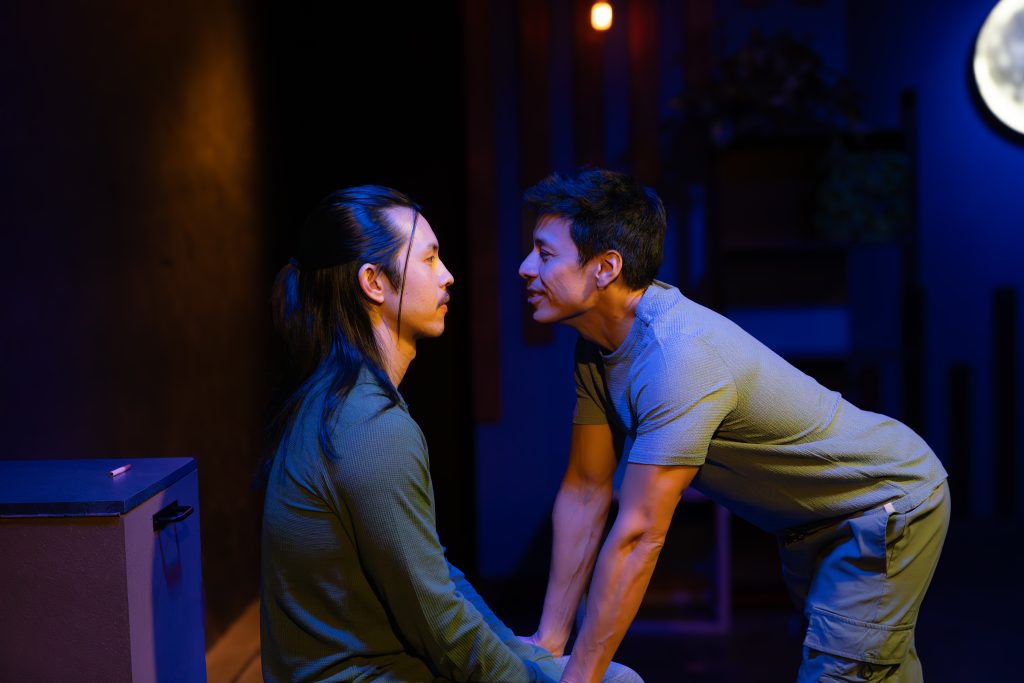 Luca and Uri face each other in dramatic stage scene