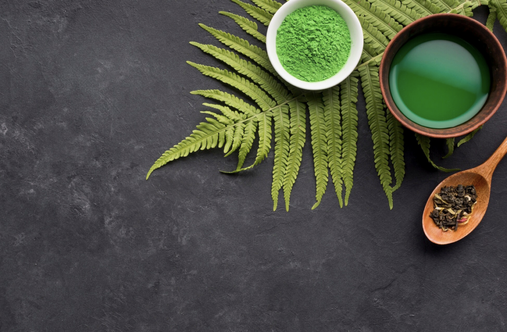 Kratom powder, kratom liquid, and dried leaves on a dark surface
