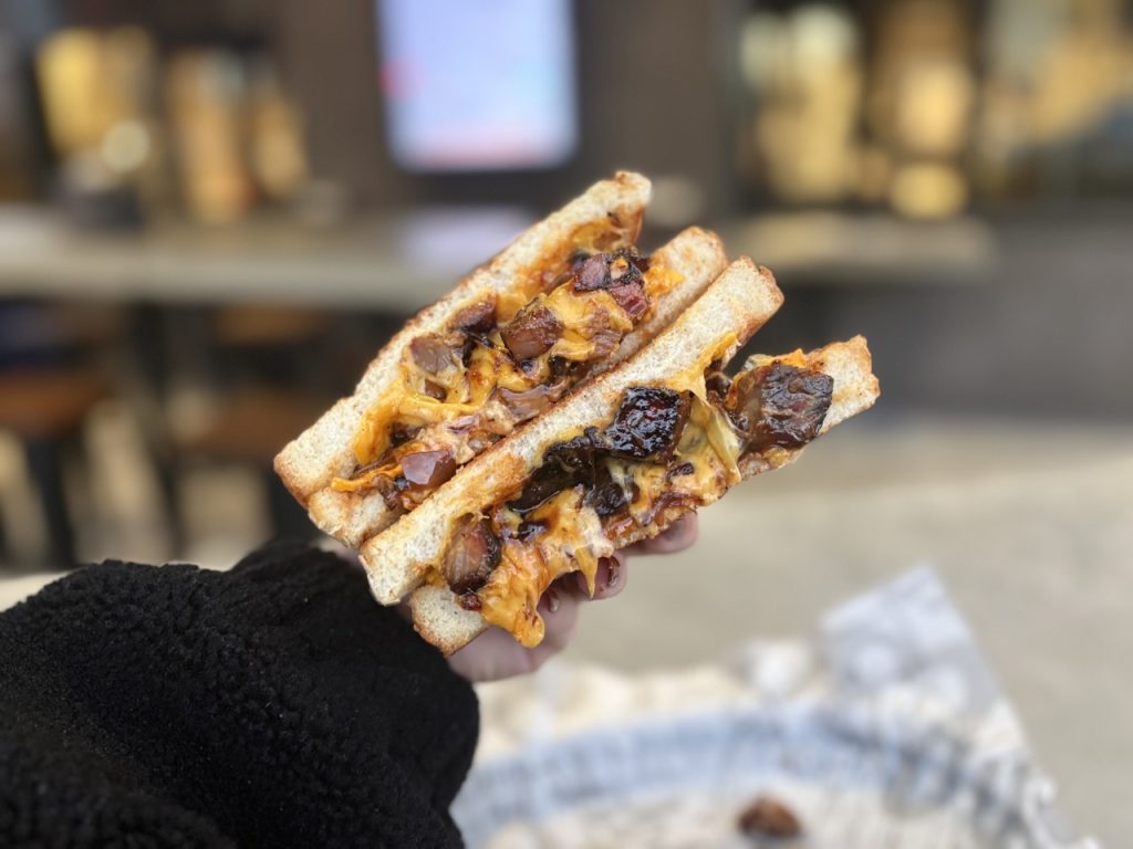 Cheesy burger sandwich with caramelized onions at Alley Burger NoHo