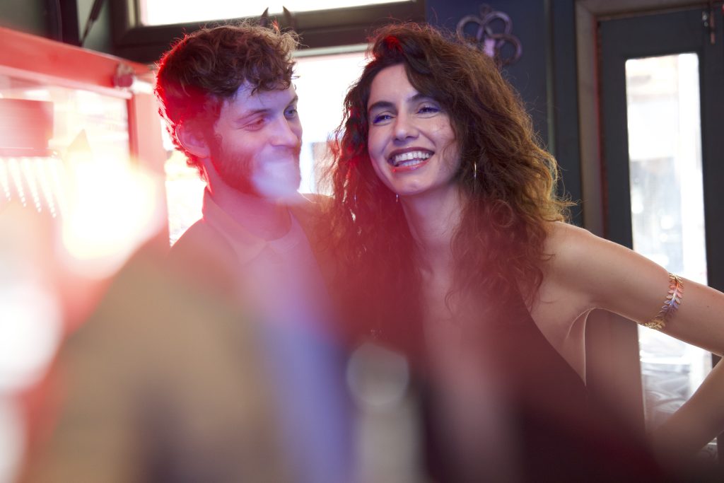 HardLove cast image of two actors smiling closely together, capturing contrast between intimacy and tension in the dark comedy