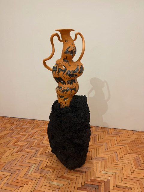 Ceramic amphora sculpture on volcanic base in Cammie Staros Pompeii