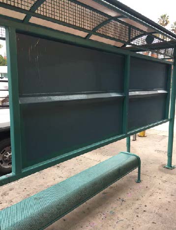 Graffiti vandalism on a North Hollywood bus stop bench and shelter before cleaning in the NoHo Arts District.
