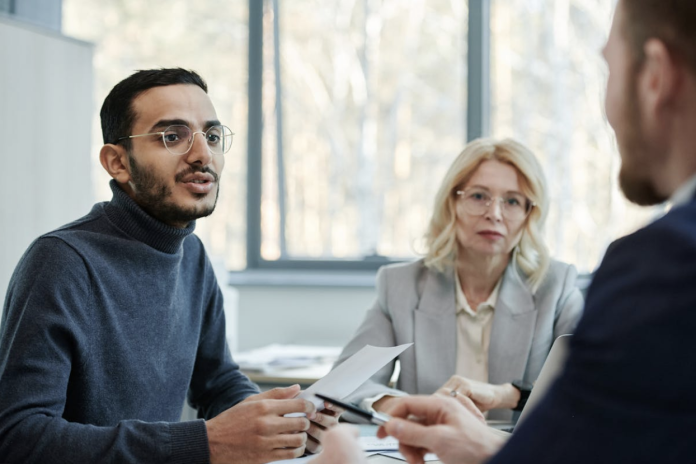 Personal injury attorney consulting clients about maximizing settlement outcomes after an accident.