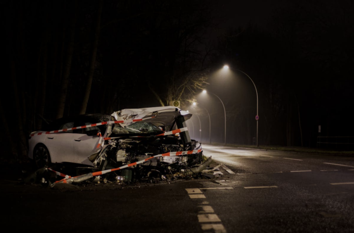 car accident scene at night with severe vehicle damage illustrating accident claims and insurance investigation process