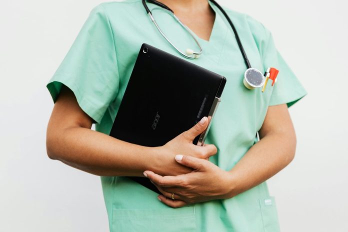 healthcare professional in scrubs holding a tablet and medical tools representing medical negligence claims and patient care in Tampa