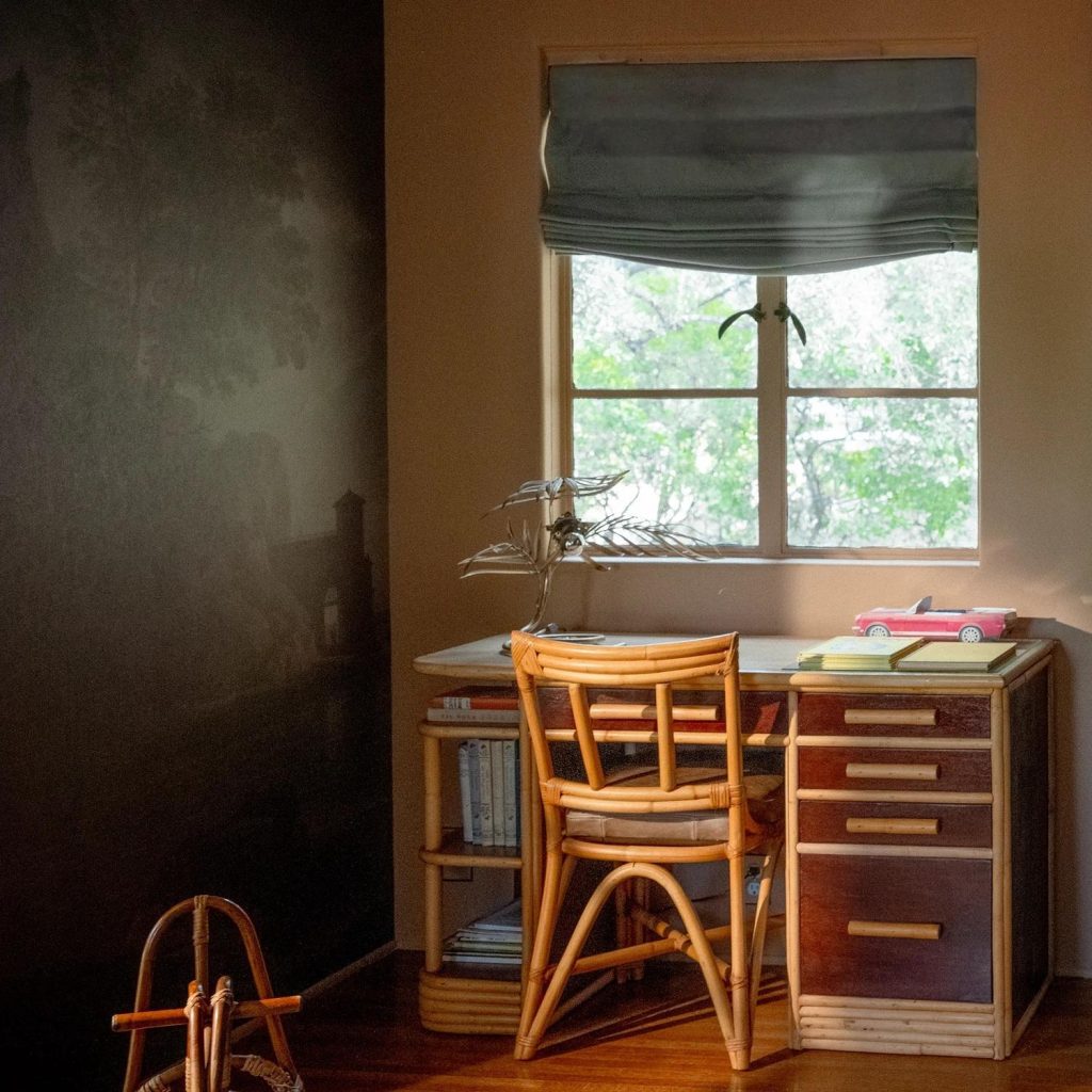 home office desk by window with natural light and wooden chair workspace
