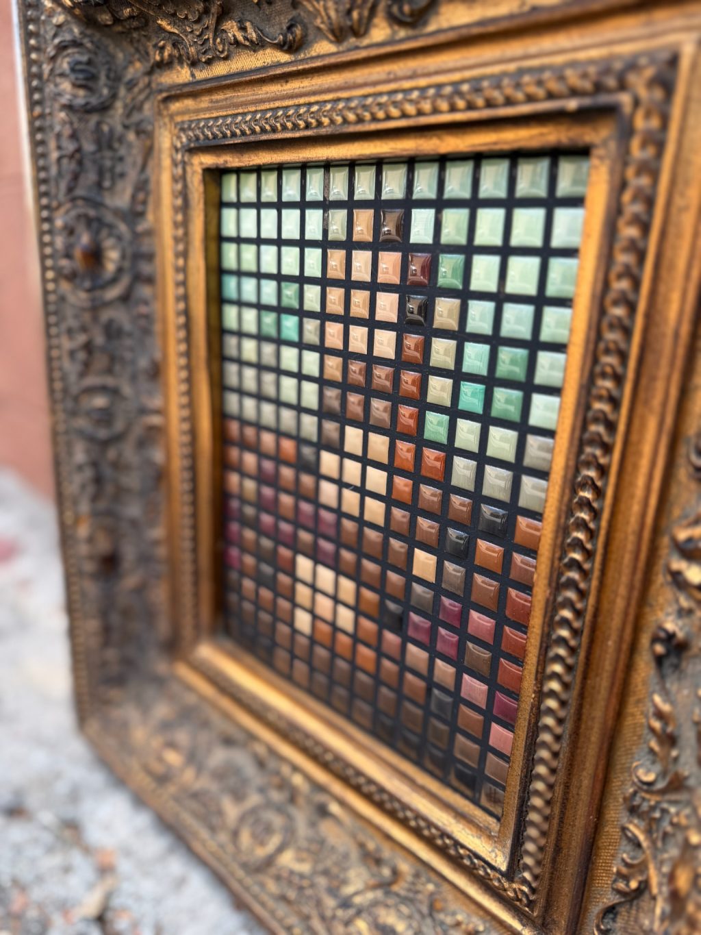 Close-up of 8-bit style resin tile artwork showing hand-painted square tiles forming a portrait inside an ornate gold frame