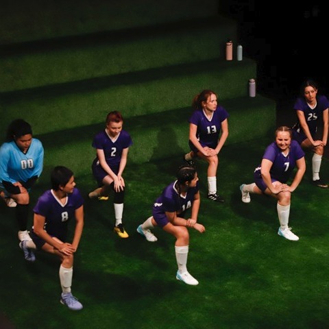 The Wolves stage production at Pierce College Theatre showing girls soccer team warming up on indoor field