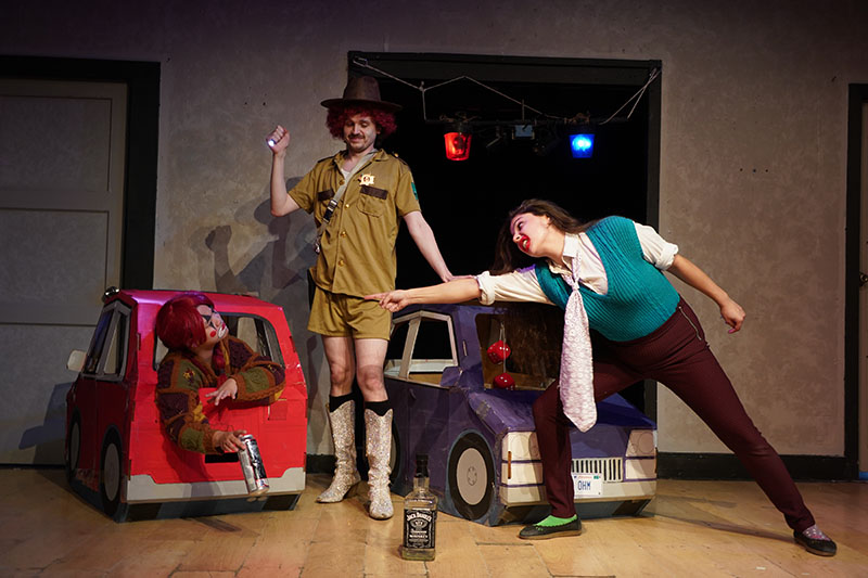 Write of Spring 2026 FIRSTS Hit and Rita stage scene with characters interacting around cardboard cars