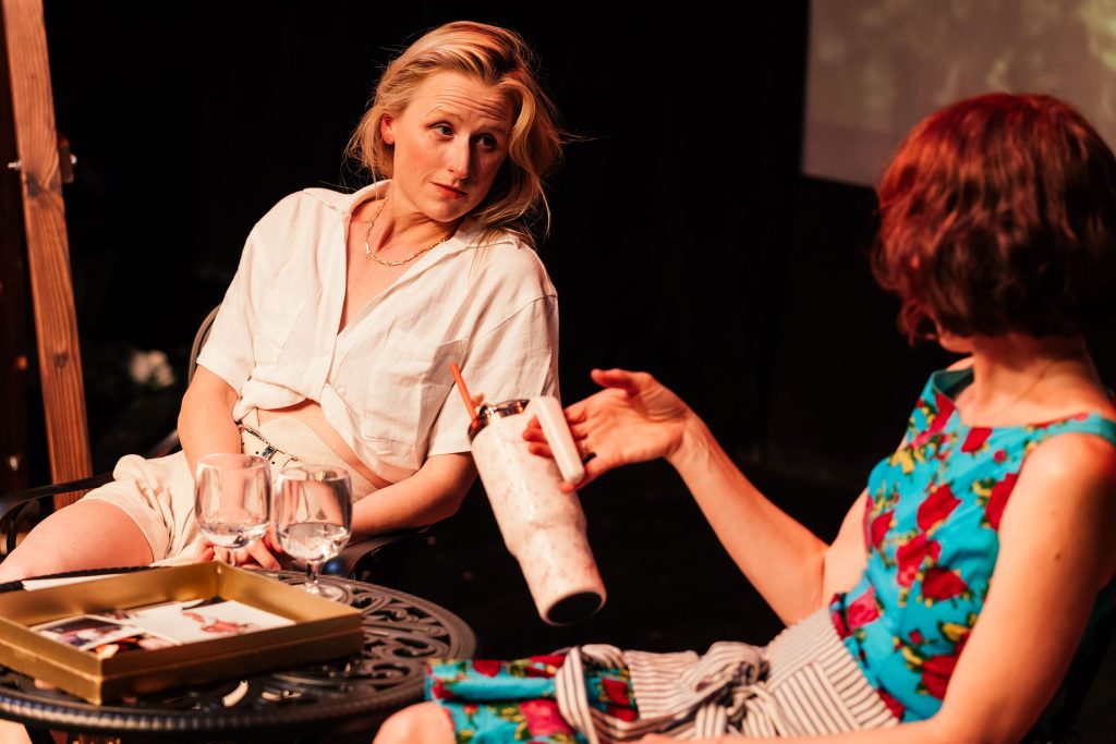 The Baptist Witches of Shelbyville scene with Mamie Gummer and Julie Shavers seated in conversation at Whitefire Theatre
