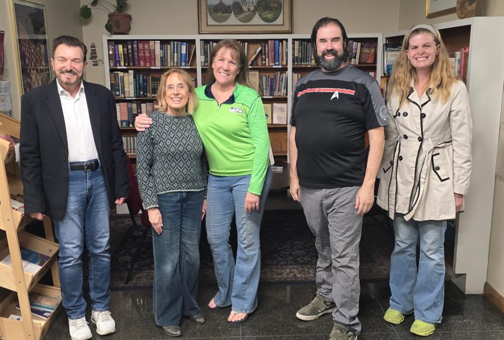 Lettice and Lovage theatre review NoHo Arts District cast members pose together in front of bookshelves before the ELATE production