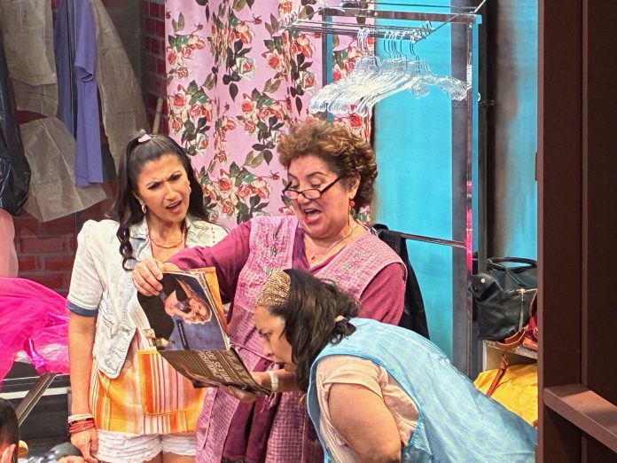 Real Women Have Curves stage production showing group of women in garment factory setting, laughing together