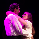 The Last Five Years stage scene showing couple in intimate moment under pink lighting at Hudson Theatre