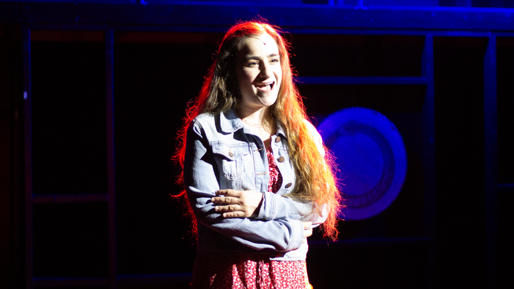 The Last Five Years musical performance at Hudson Theatre featuring female vocalist under stage lighting