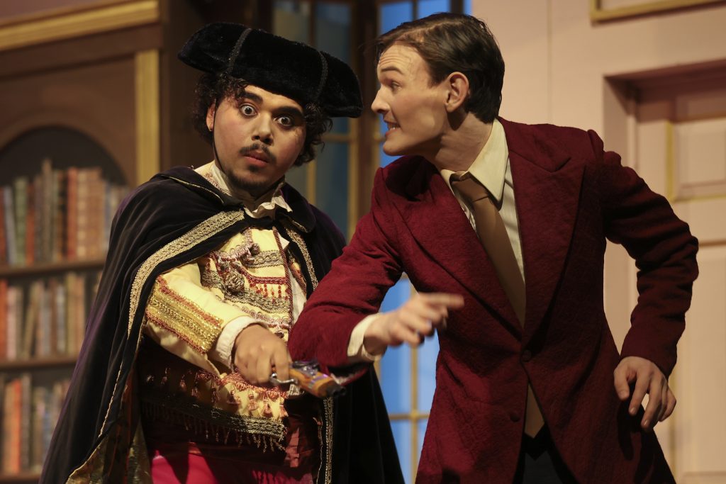 Two actors perform an exaggerated farce scene with comic tension and expressive gestures in A Flea in Her Ear at LAPC Theatre