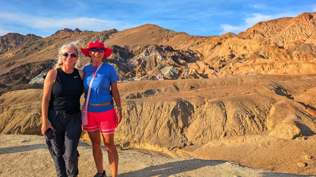 Travelers exploring the colorful rock formations of Artist Palette in Death Valley National Park.