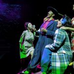 Raúl Cardona as El Pachuco sings alongside cast members in a powerful musical moment from Los Angeles Mission College’s production of Zoot Suit.