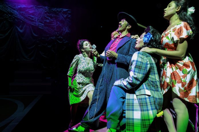 LAMC Stage Zoot Suit 2026-531 Raúl Cardona as El Pachuco sings alongside cast members in a powerful musical moment from Los Angeles Mission College’s production of Zoot Suit.