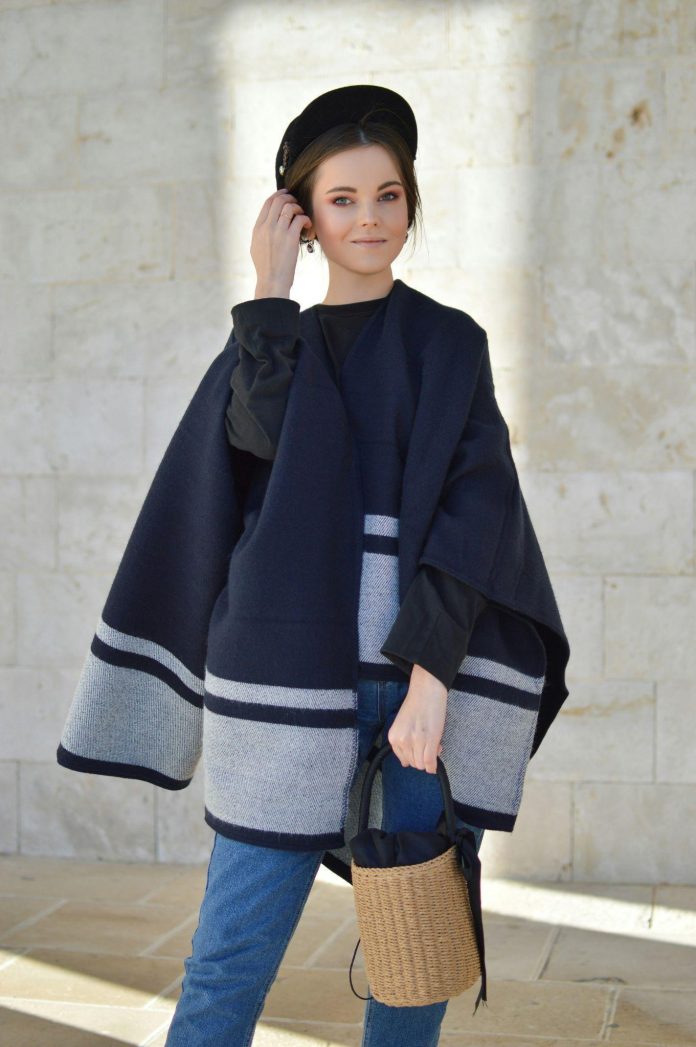 Woman wearing layered creative and comfortable fashion with textured knitwear and relaxed styling
