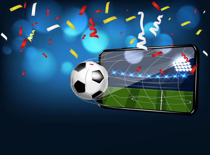 Soccer ball flying out of a smartphone screen during a fast-paced mobile sports gaming and online betting concept.