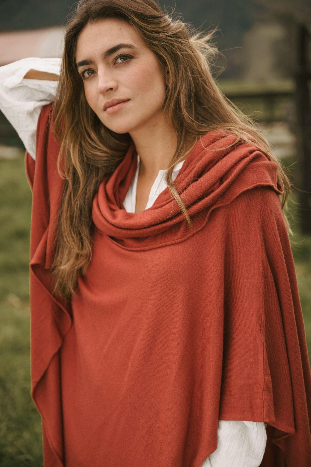 Woman wearing layered creative and comfortable fashion with textured knitwear and relaxed styling