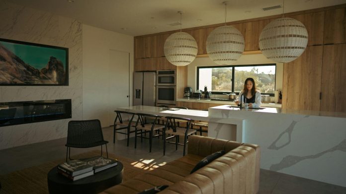 image Modern open-concept living room and kitchen with clean surfaces, organized layout, natural sunlight, and minimalist interior design focused on home organization and maintenance.