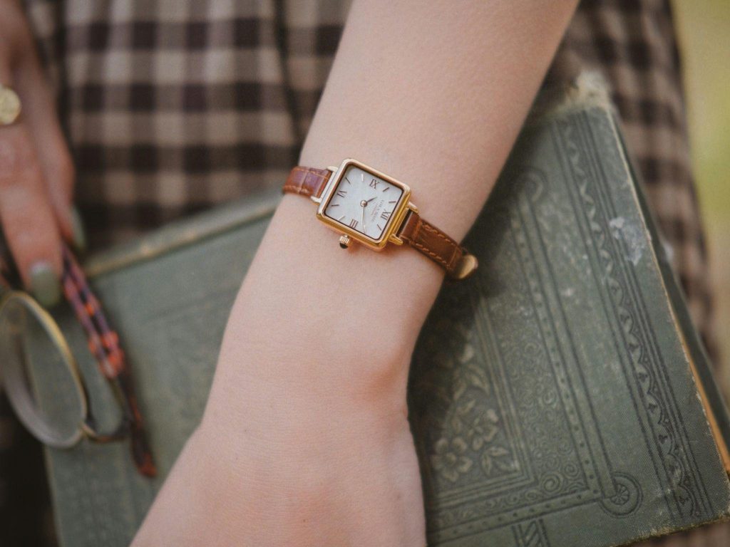 Vintage-inspired women’s watch paired with classic accessories and timeless personal style details