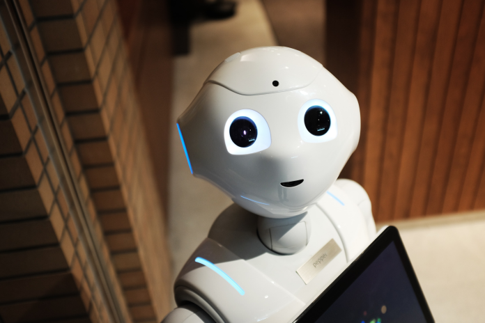 Humanoid AI receptionist robot standing in a modern office environment representing future customer service technology and business automation
