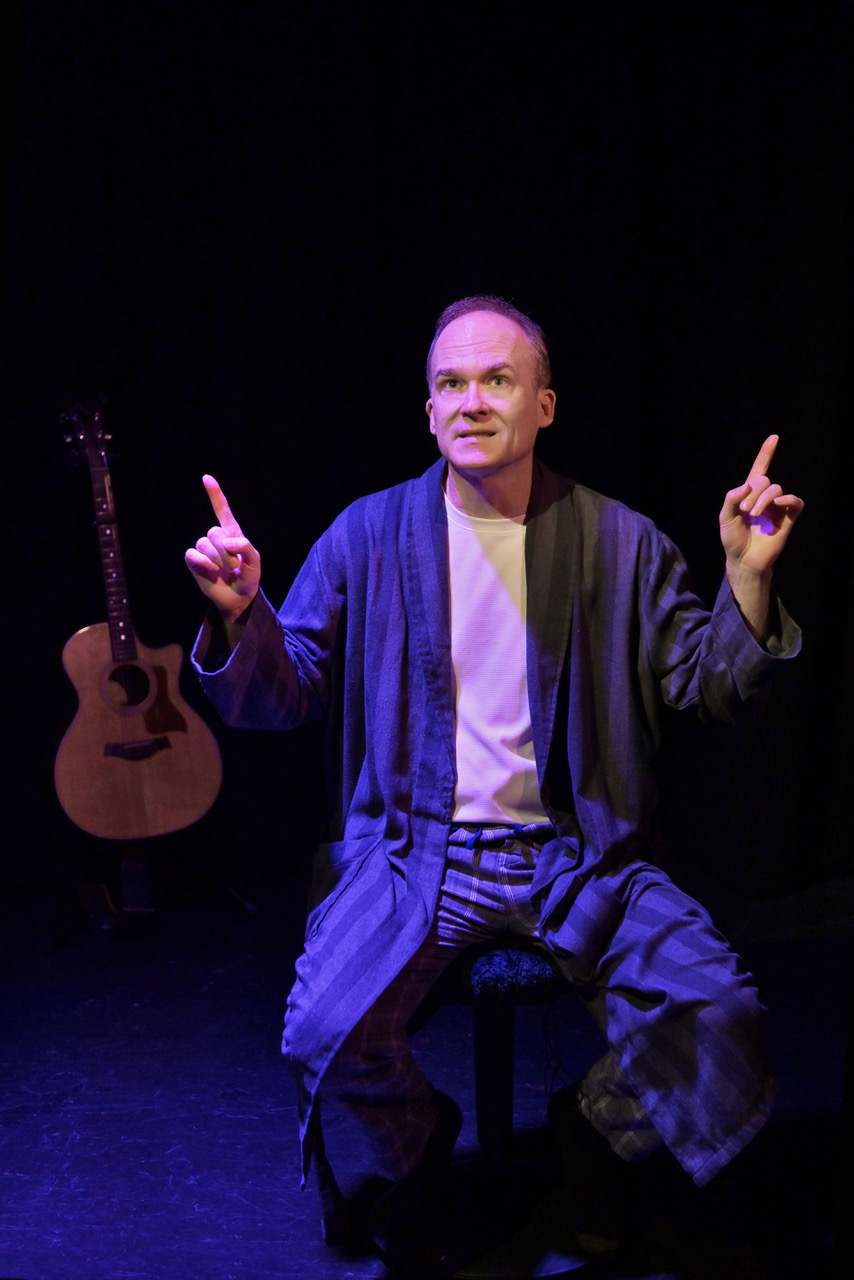 Stefan Marks gestures animatedly during My One Woman Show (The Search for a Truthful Moment) at the 2026 Hollywood Fringe Festival.