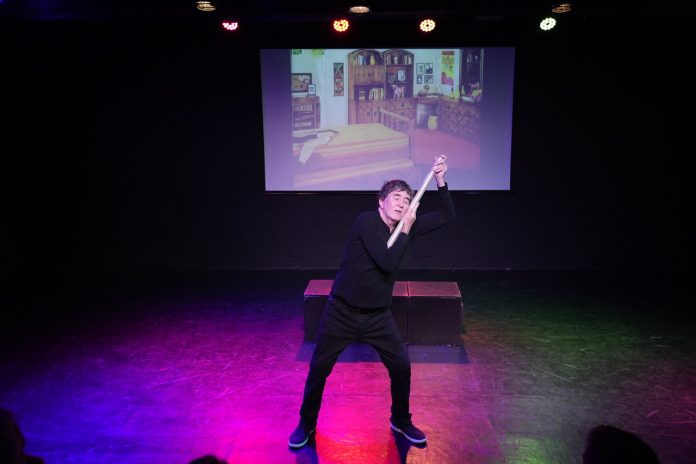 David Pavao performs a humorous moment in Poster Child: How Charlie's Angels Kicked My Ass Out of The Closet during the 2026 Hollywood Fringe Festival.