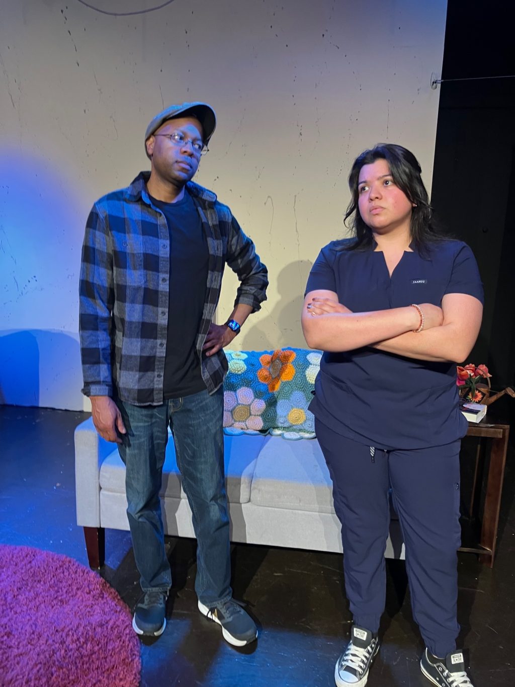 Two cast members in Act Your Age confront a difficult family conversation on stage.