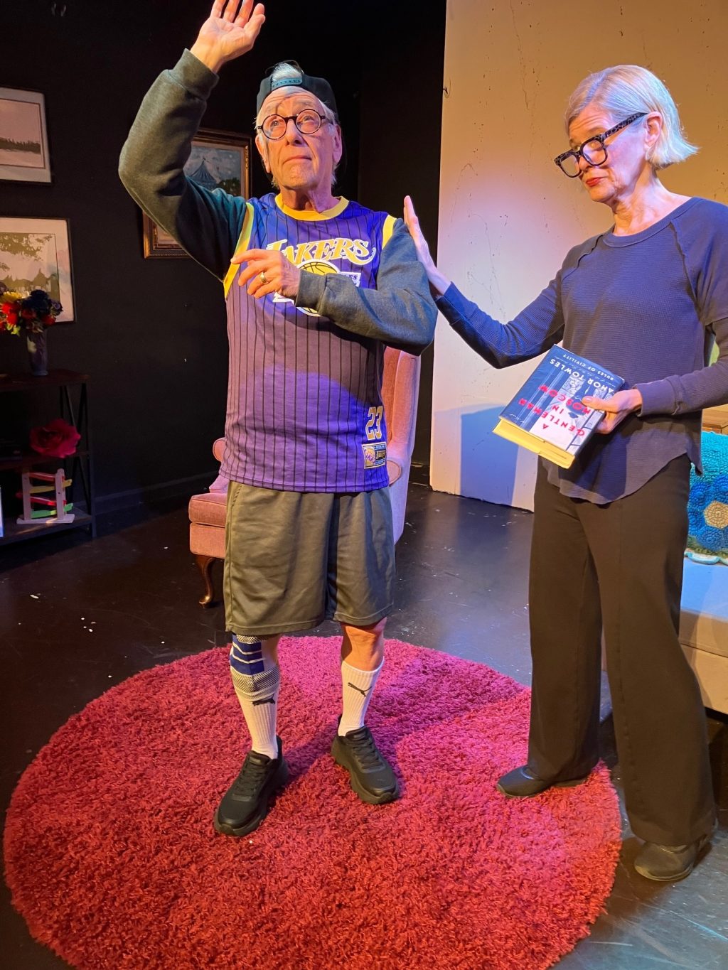 A scene from Act Your Age as Jake resists aging while his wife looks on with concern.