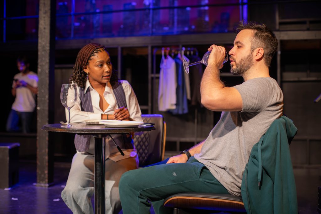 Brianna Bell and Michael Dukakis share a charged restaurant scene in Punish Me at the Hollywood Fringe Festival.