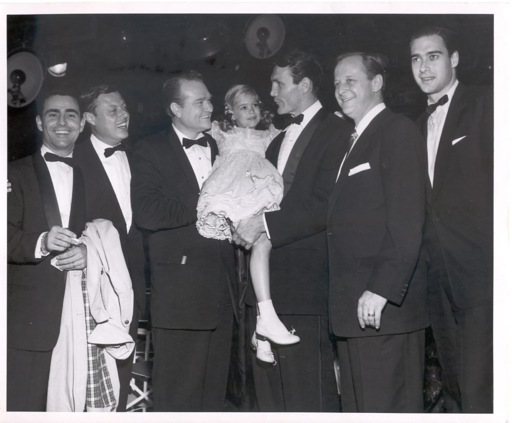 Young Evelyn Rudie poses with television and film stars at an awards event during her childhood acting career.